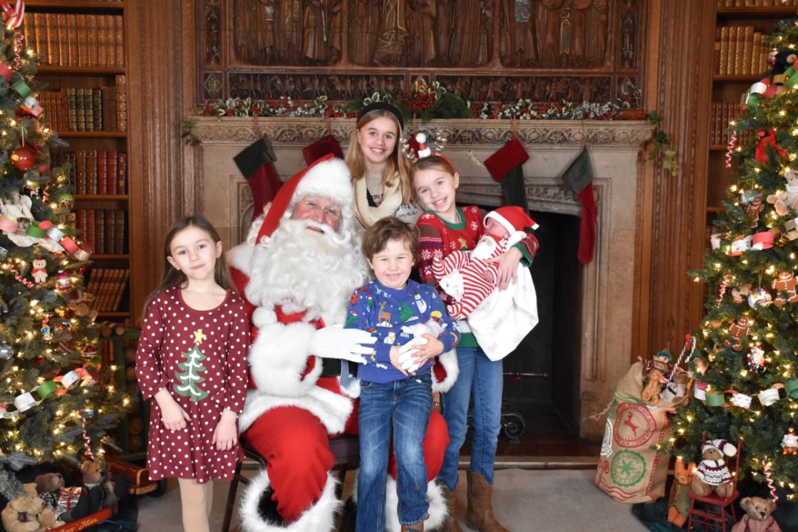 Photo of a family visiting Santa in the Cranbrook House Library.