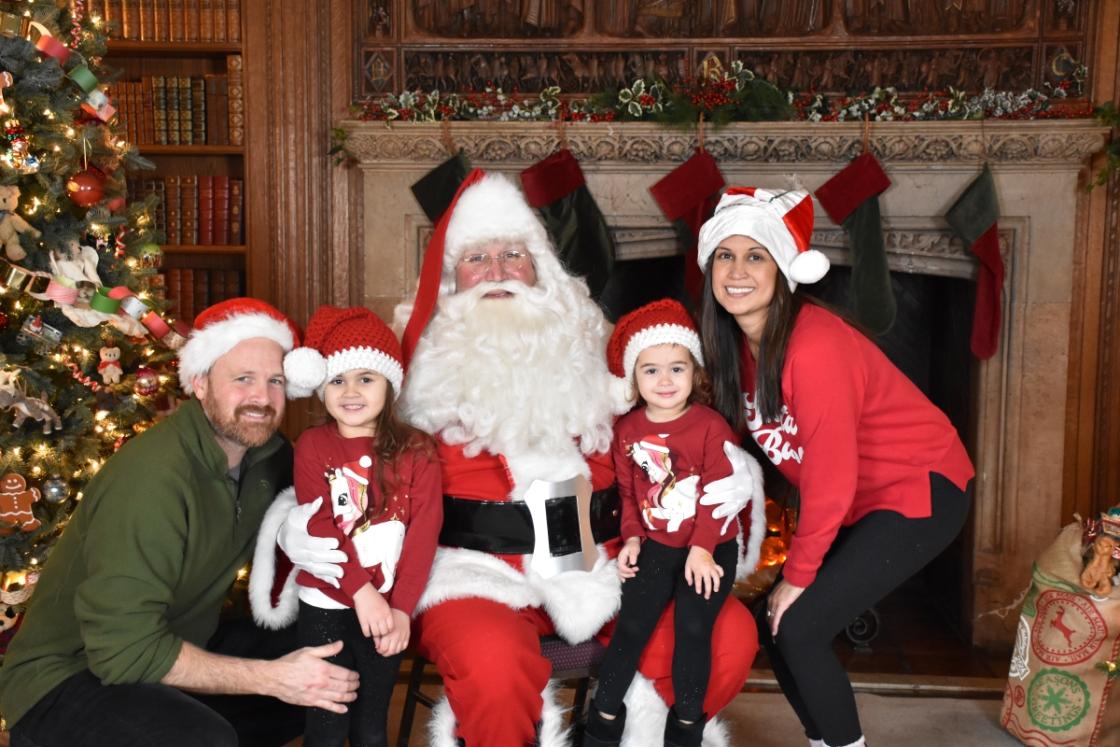 Photo of a family visiting Santa in the Cranbrook House Library.