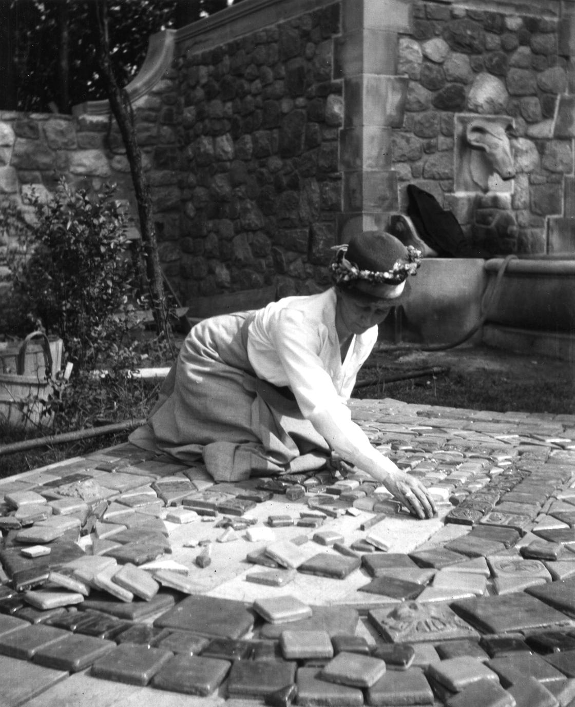 Photograph of Mary Chase Perry Stratton laying Pewabic tiles at Rainbow Fountain.